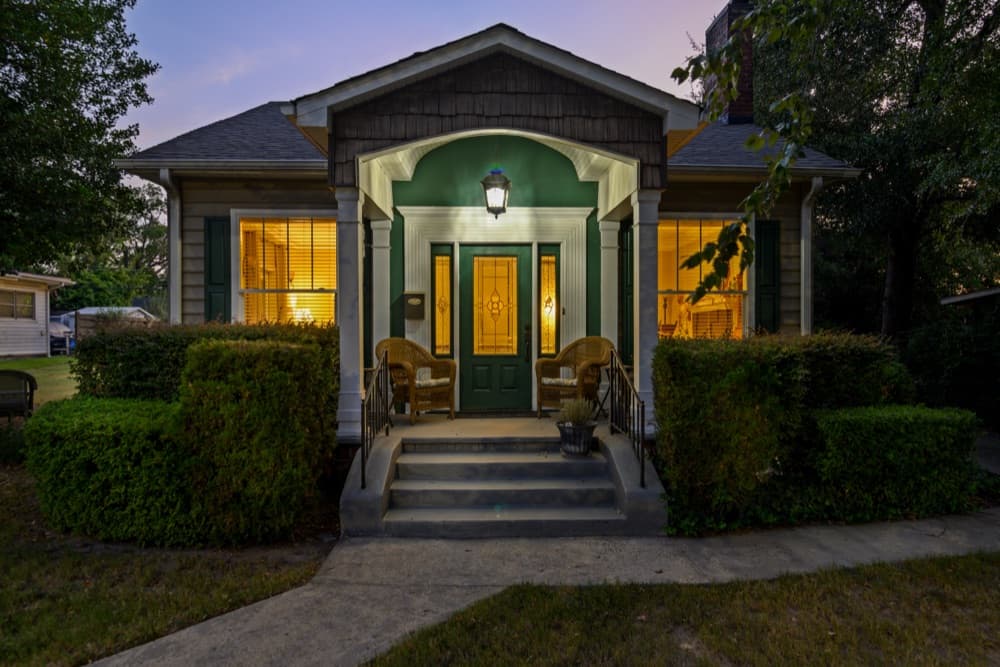 Craftsman bungalow front porch at twilight with lit windows, Rock Hill, SC