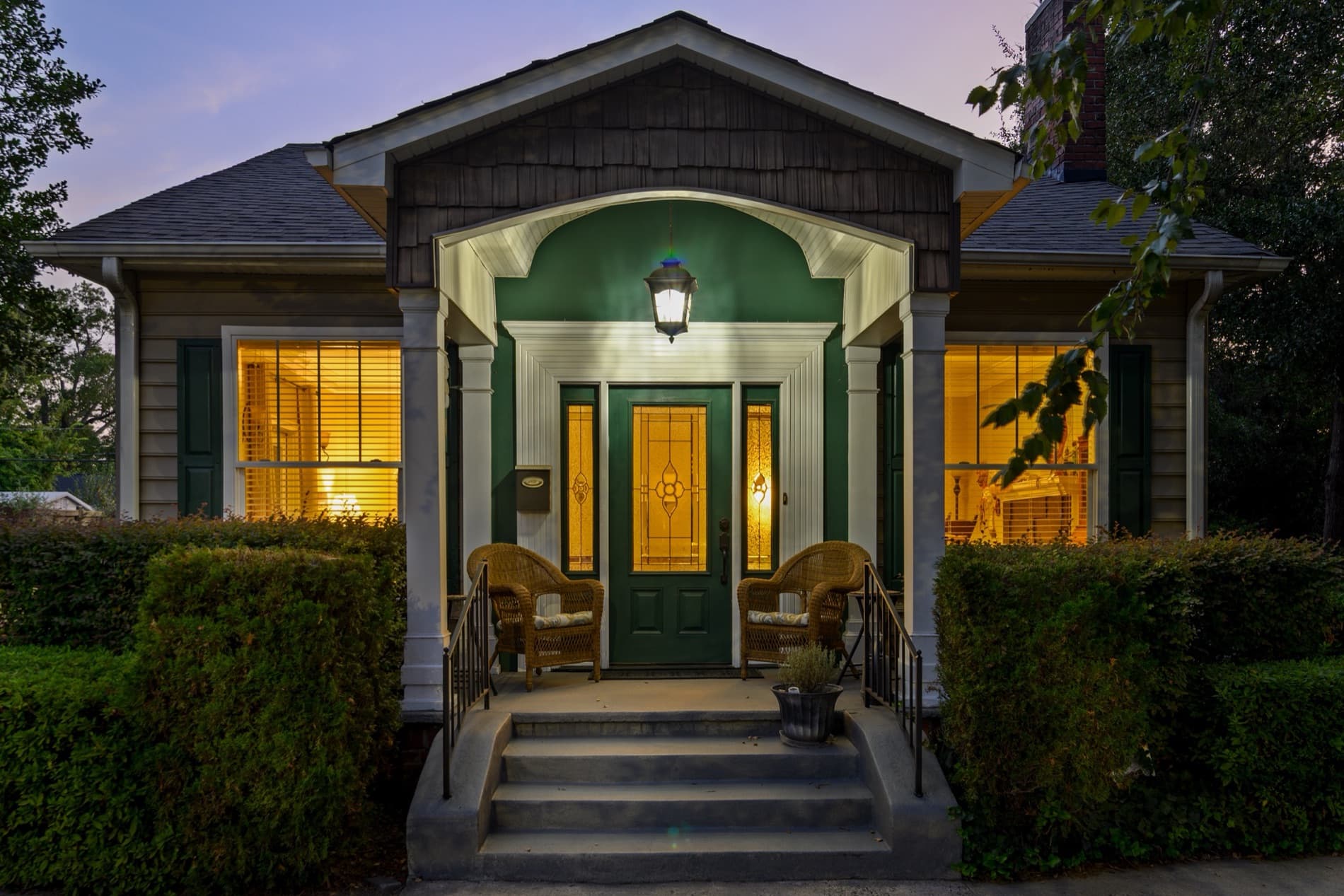 Craftsman bungalow front porch at twilight with lit windows, Rock Hill, SC